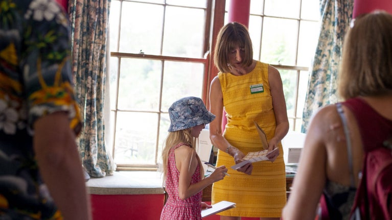 Volunteer Room Guide at Killerton speaking with viistors